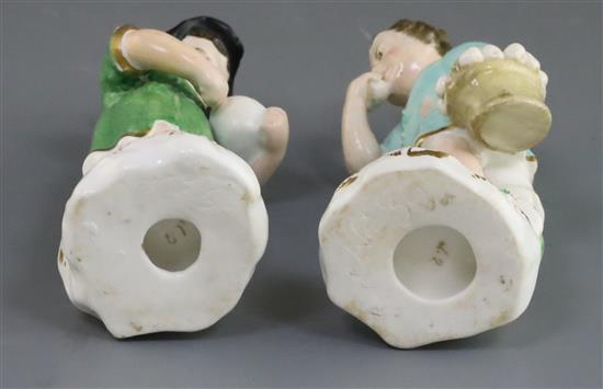 A pair of Rockingham porcelain figures of a beggar boy and girl, c.1830, h. 12.5cm